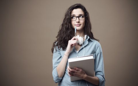 Cute student girl taking notes